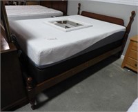 Queen Cherry bed with Simmons Mfg. Co. pillow