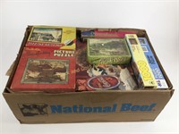 Box lot of puzzles including coke puzzle