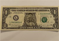 Genuine one dollar bill with Santa sticker