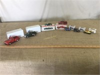 Miniature Scale cars and trucks with boxes.