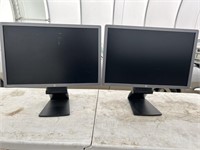A pair of Hp EliteDisplay E241i computer monitors