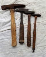 4 hammers, one has nail puller on end of handle