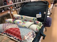 Suitcase with comforter and pillow