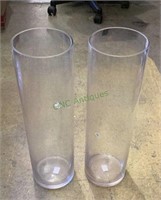 Two tall cylindrical glass vases - one does have a