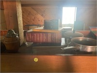 Wooden lantern base, books, pans, vintage camera.
