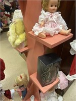 Shelf with dolls and dollhouse furniture