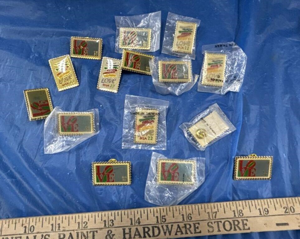 Assorted Pins of Postage Stamps That Say "Love"