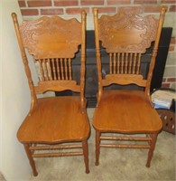 (2) Antique oak carved kitchen chairs.