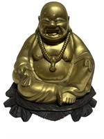 Brass smiling Buddha figure on wooden base