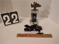 Snowmobile toy and a snowmobile trophy.