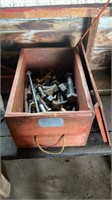 Assorted large bolts and nuts in a wooden storage