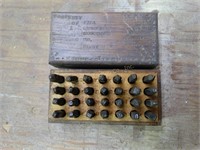 Metal letter punches in wood box