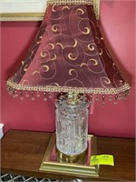 Table lamp with gold colored base clear middle and