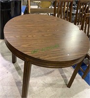 Vintage round dining table with 2 12 inch sleeves.