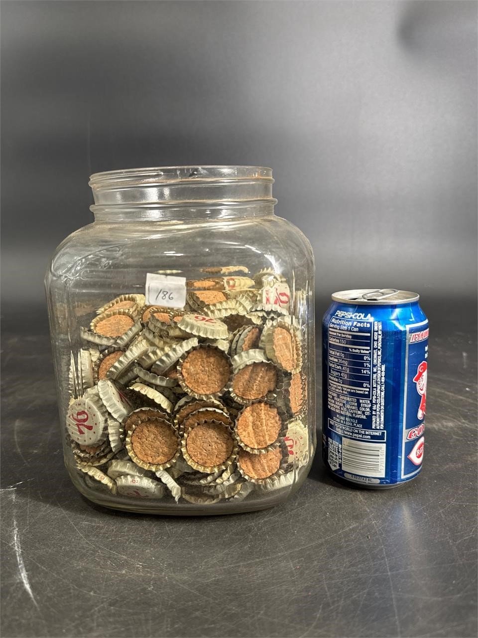 JAR FULL OF 76 COLA UNUSED CORK LINED CAPS