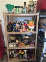 Shelf with cleaners, paint, sprayers.
