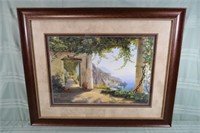 Large framed print depicting a Mediterranean coast