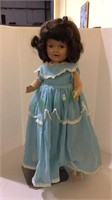 Antique children’s doll includes stand