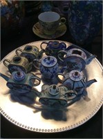 Eight small metal tea pots