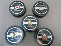Assortment of National Hockey League Pucks