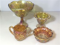 Lot of assorted orange carnival glass pieces.