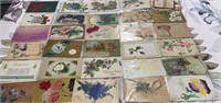 various used vintage embossed postcards featuring