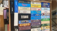 Various VCR movies, cassette tapes and holder