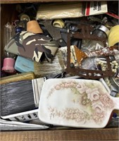 Contents of drawer including paint brushes