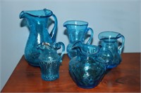 Lot of blue glass handled pitchers/creamers 2