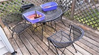 Metal patio table and four chairs. Approximately
