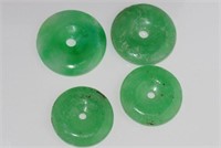 Four various round jade pendants