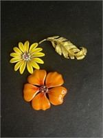 Three retro costume brooches. One missing a pearl