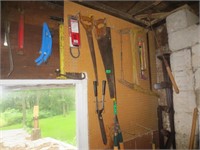 Contents of wall, lopers, bar, buck saw, misc