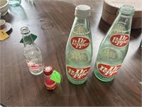 Antique Dr Pepper bottles, one with lid, crown