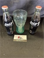 Coca Cola bottles and glass