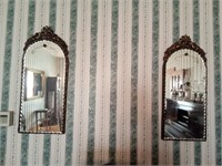 Half oval beveled mirrors with floral carvings