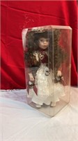 Doll with red/white in plastic case