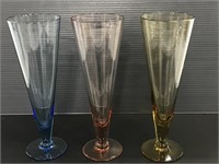 Three colorful glass parfait dishes