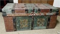 Metal shipping or travel trunk.  Ornate design