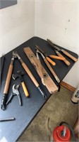 Bucket of loppers, yard tools, and more
