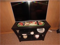Flat screen Tv w/ stand & contents.