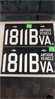 Pair of antique vehicle license plates.
