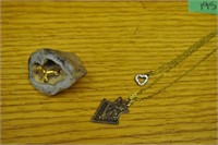 2 necklaces and geode with seal inside