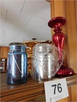 2 illuminated mercury looking mason jar candles -