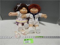 2 Cabbage Patch dolls and an extra pair of shoes