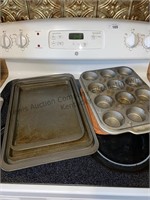 Box of muffin pans, baking sheets, cake pans,