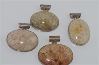 Four silver and stone set pendants