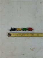 Set of four tiny metal trains