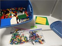 Tote containing some Lego type toys; toy action fi