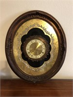 Orate Oval Wall Clock in Gold & Black is 25x21